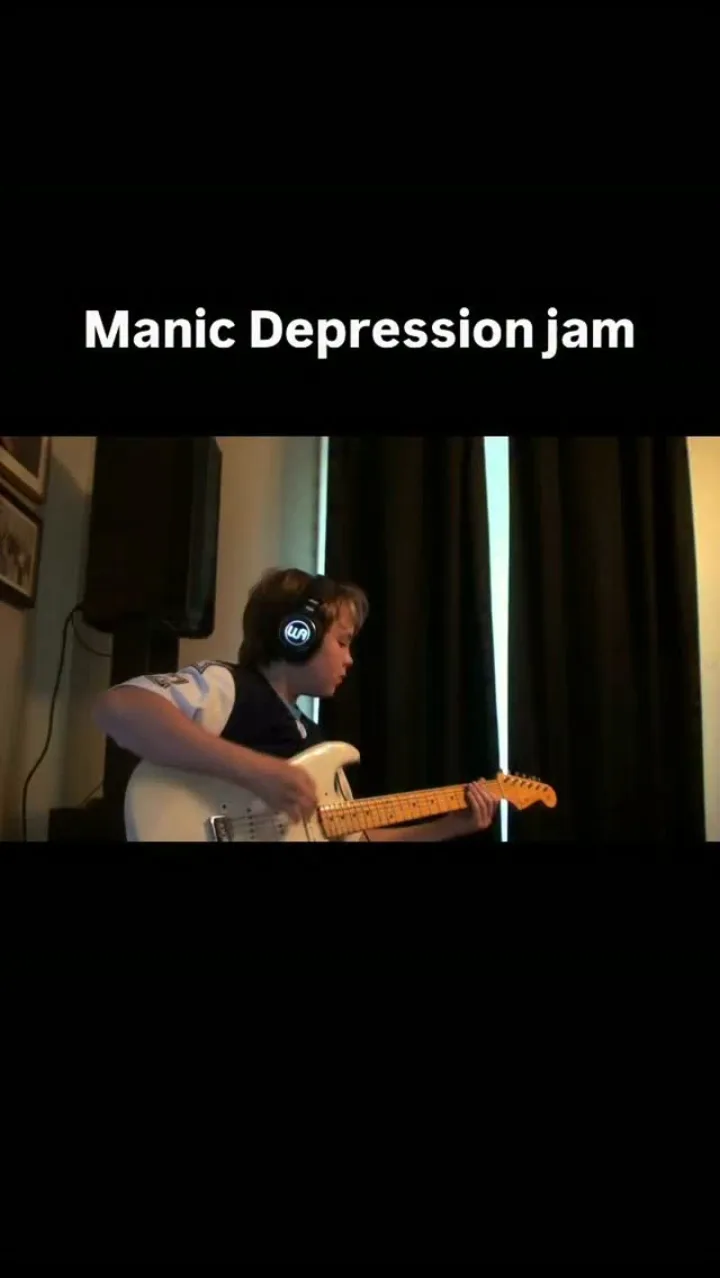 Emmitt DeWater playing a white Stratocaster with headphones on