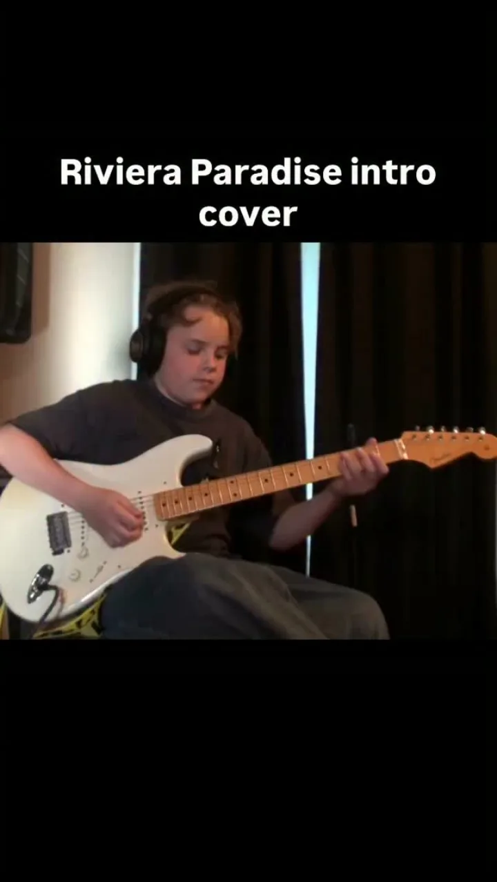 Emmitt DeWater playing a white Stratocaster for a Riviera Paradise intro