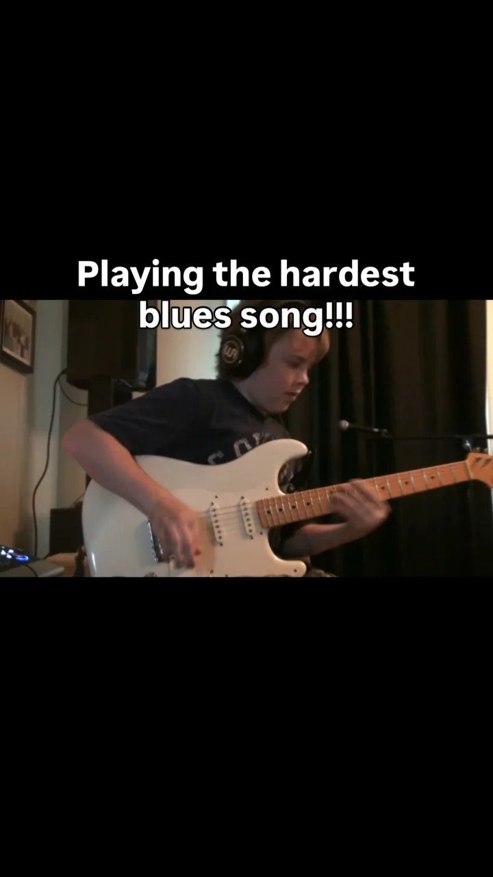 Emmitt DeWater playing a white Stratocaster beneath the words Playing the hardest blues song